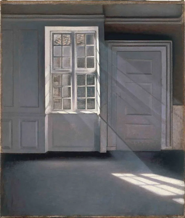 A quiet room with sunlight falling through a tall window onto the floor